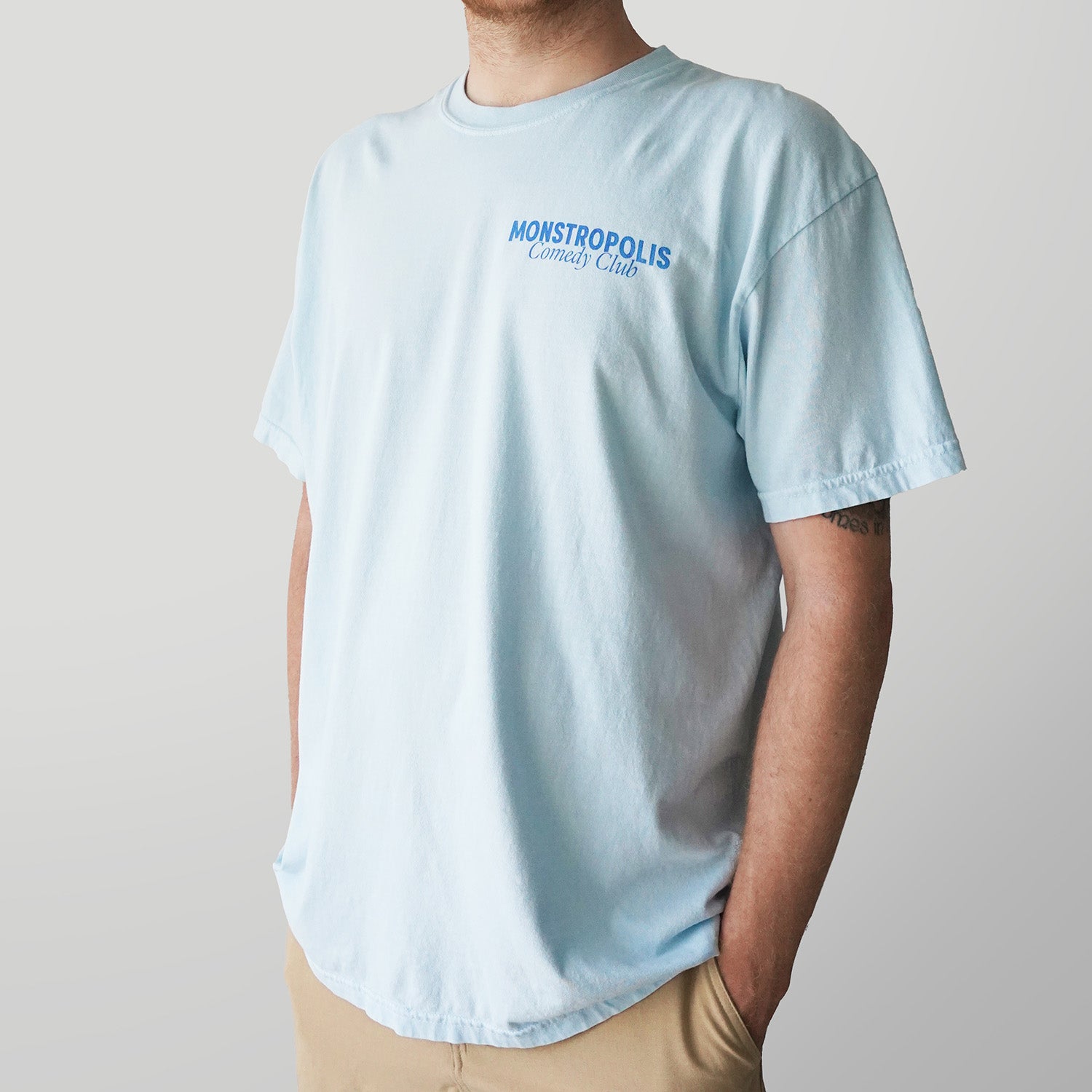 Front view of Disney-inspired Monstropolis Comedy Club t-shirt with small Monstropolis Comedy Club logo on the left chest.