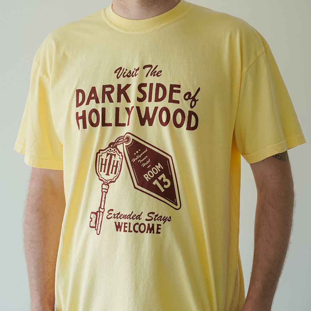 Front view of Disney-inspired Dark Side of Hollywood t-shirt featuring the phrase ‘Visit The Dark Side of Hollywood,’ an image of a hotel key labeled Room 13, and the text ‘Extended Stays Welcome.'