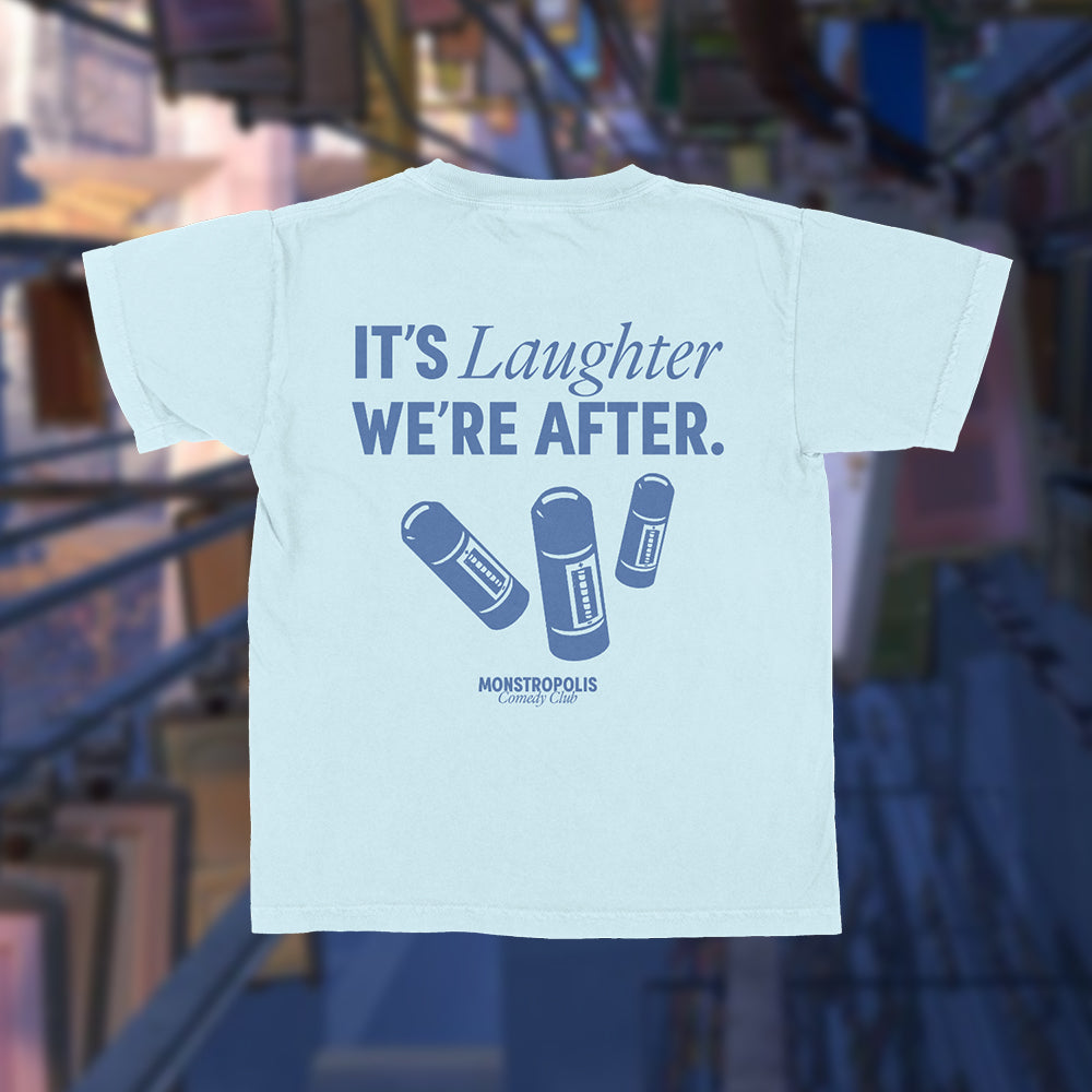 Back view of Disney-inspired Monstropolis Comedy Club crop top with the phrase ‘It’s Laughter We’re After’ above three laugh canisters and Monstropolis Comedy Club text underneath.