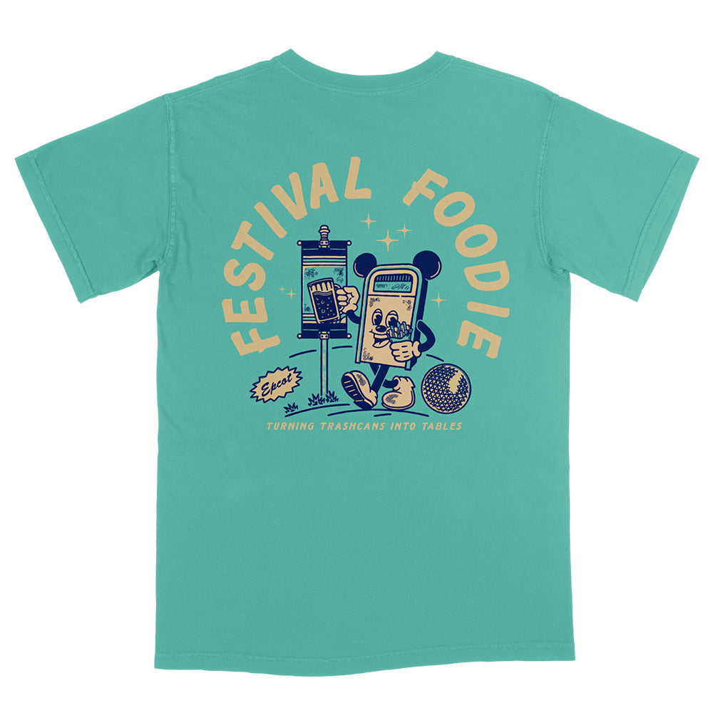 Back view of Disney-inspired Festival Foodie t-shirt with the phrase ‘Festival Foodie’ above a cartoon trash can with Mickey ears walking around the world, holding a beer and french fries, and smaller text reading ‘Turning Trashcans Into Tables.’