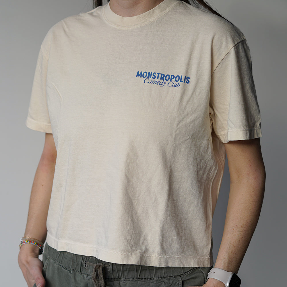 Front view of Disney-inspired Monstropolis Comedy Club crop top with small left chest logo text reading Monstropolis Comedy Club.