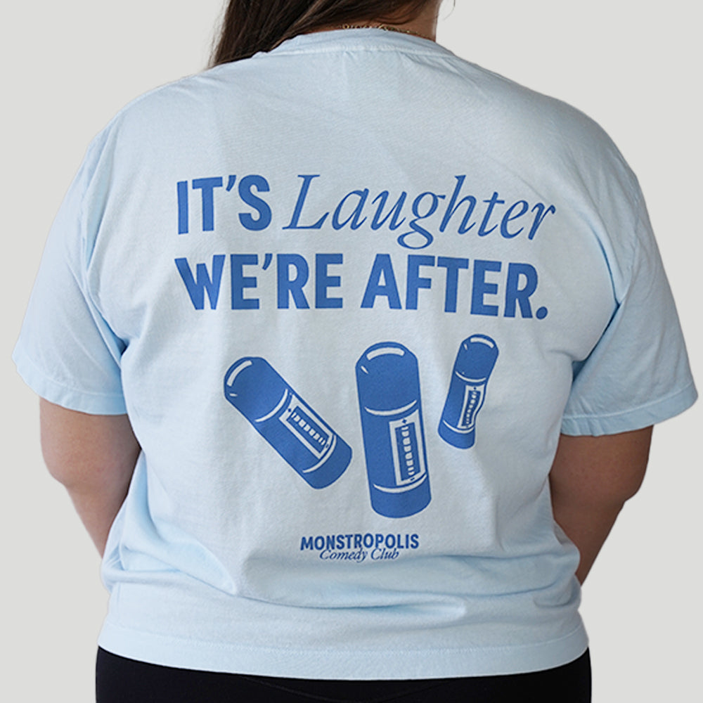 Back view of Disney-inspired Monstropolis Comedy Club crop top with the phrase ‘It’s Laughter We’re After’ above three laugh canisters and Monstropolis Comedy Club text underneath.