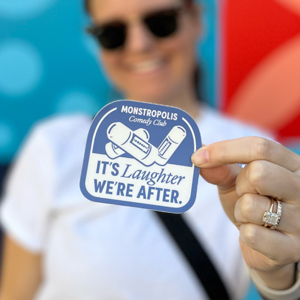 Monstropolis Comedy Club Disney-inspired sticker with phrase ‘It’s Laughter We’re After’ and three laugh canisters.