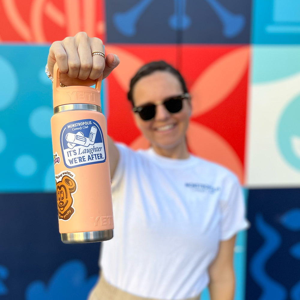 Monstropolis Comedy Club Disney-inspired sticker with phrase ‘It’s Laughter We’re After’ and three laugh canisters.